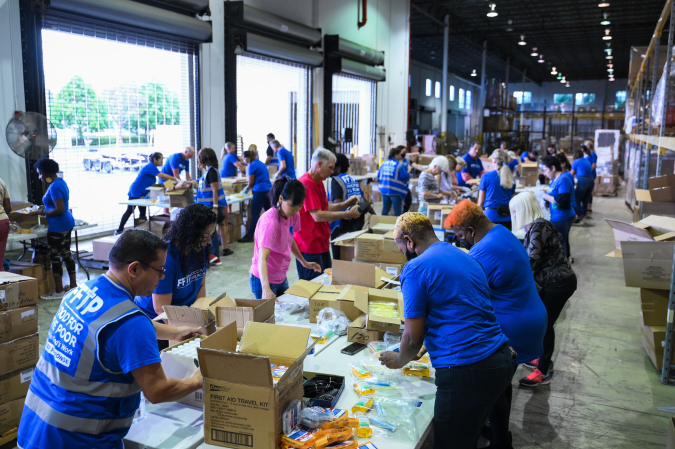 Volunteers pack items at Food For The Poor's first Hearts United Community Day.