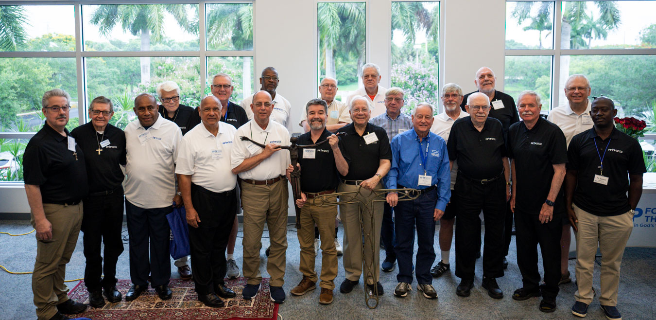 Twenty FFTP Clergy Speakers stand in the prayer room at FFTP headquarters, during the Clergy Speakers Convocation.