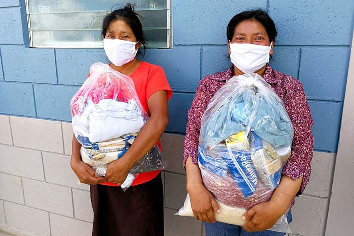 Honduras - Two females holding donation food supply