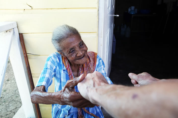 Elderly woman receiving a helping hand